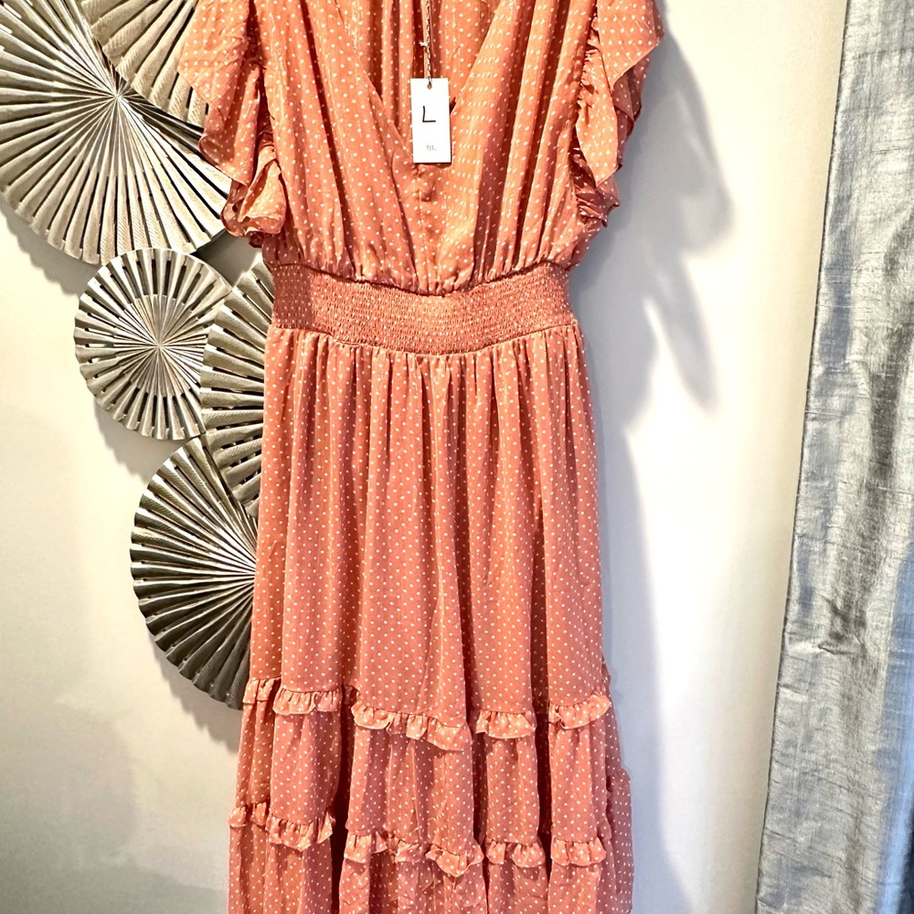 Blush polka dot dress with pretty ruffles.